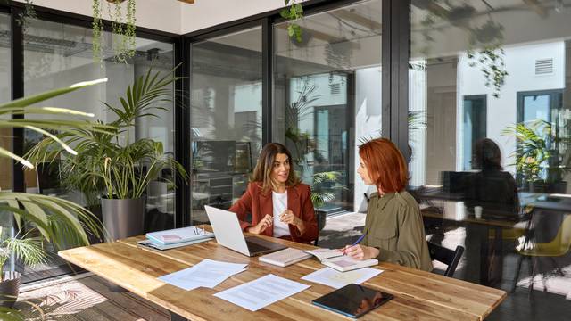 Two,Busy,Business,Women,Of,Young,And,Middle,Age,Talking