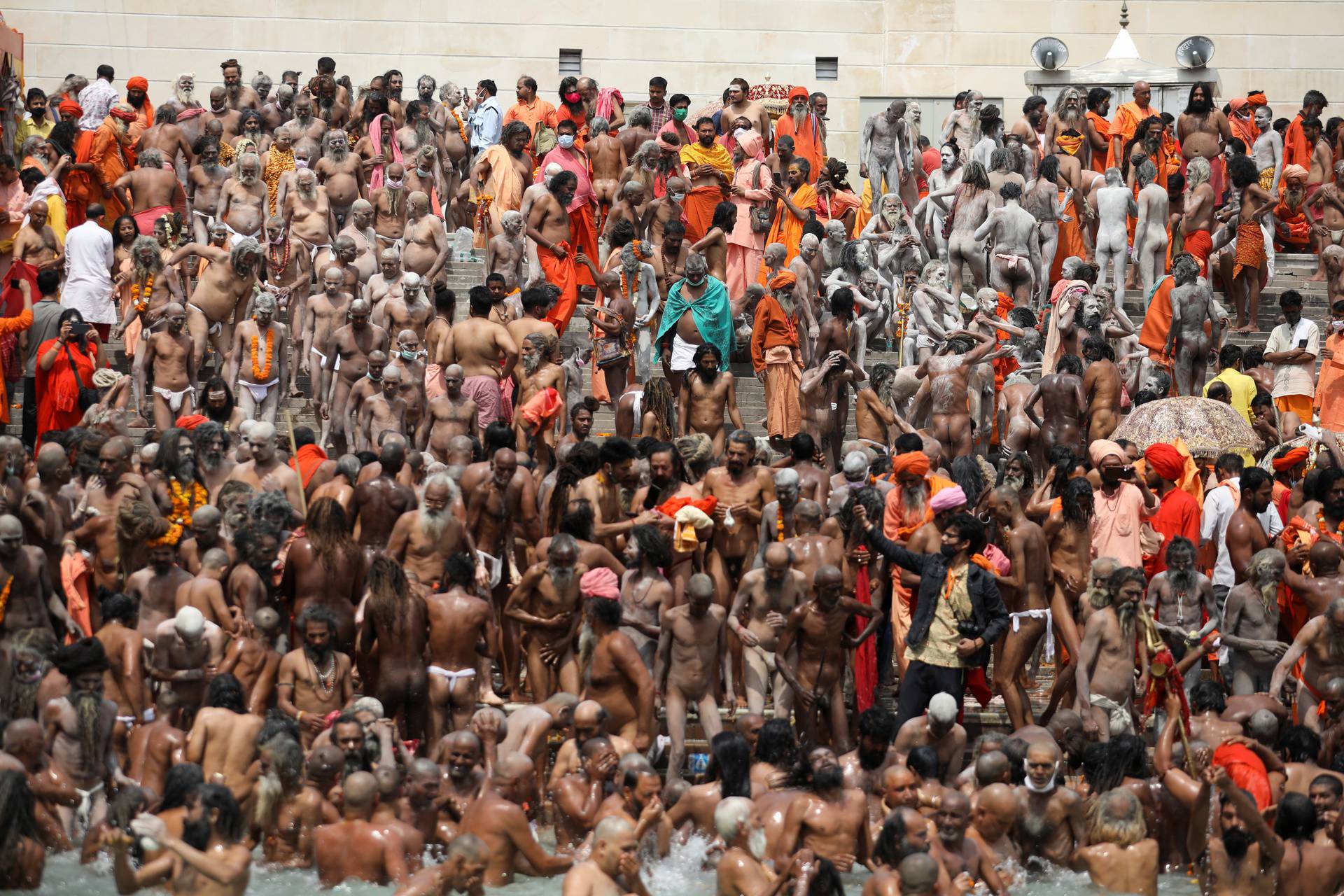 Naga Sadhus, or Hindu holy men, take a dip in the Ganges river during the second Shahi Snan at Kumbh Mela, in Haridwar