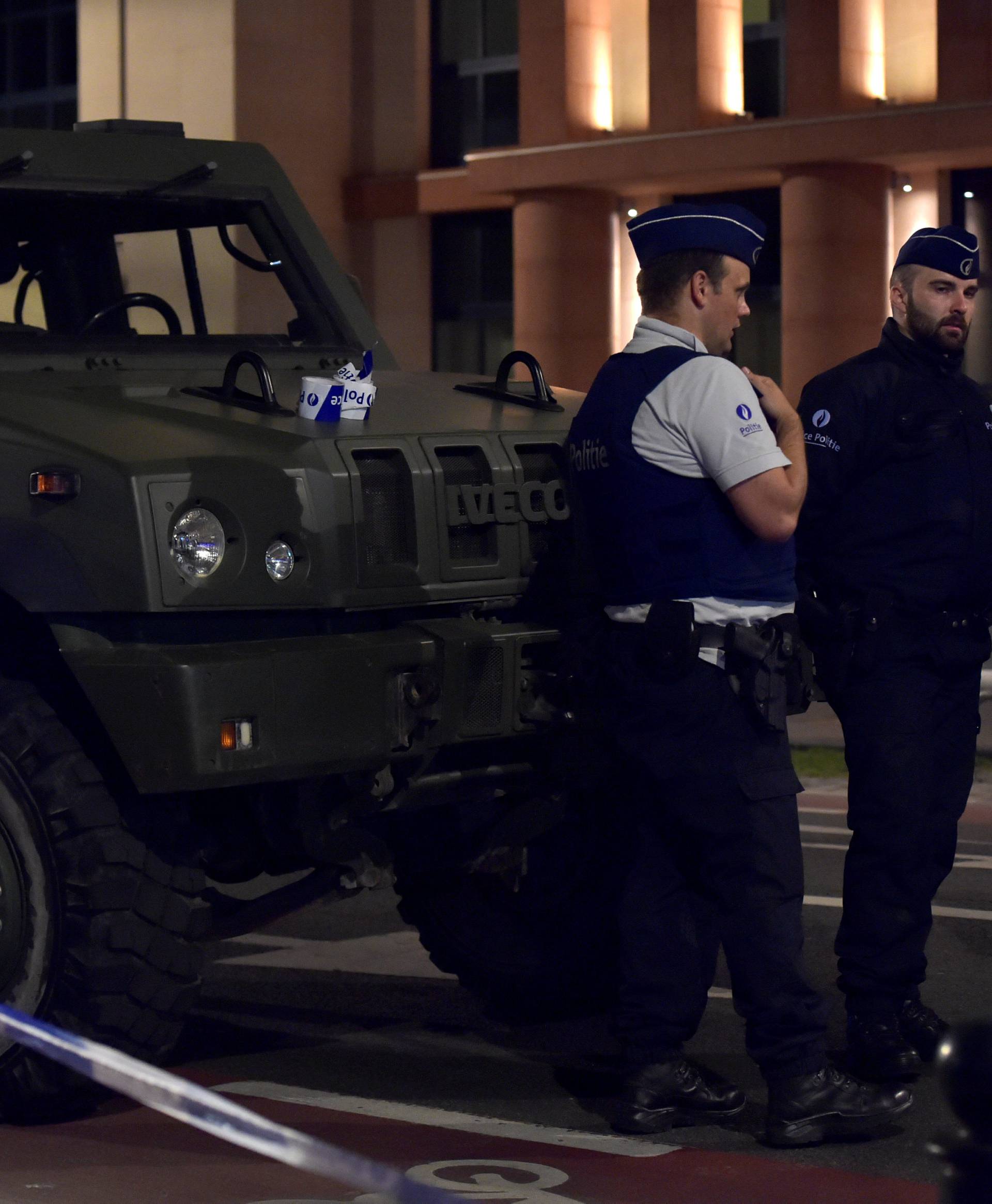 Policemen react on the scene after Belgian soldiers shot a man who attacked them with a knife, in Brussels