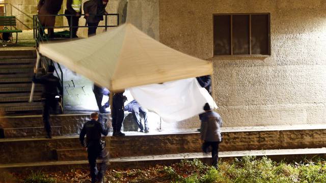 Police cover a body after a shooting outside an Islamic center in central Zurich