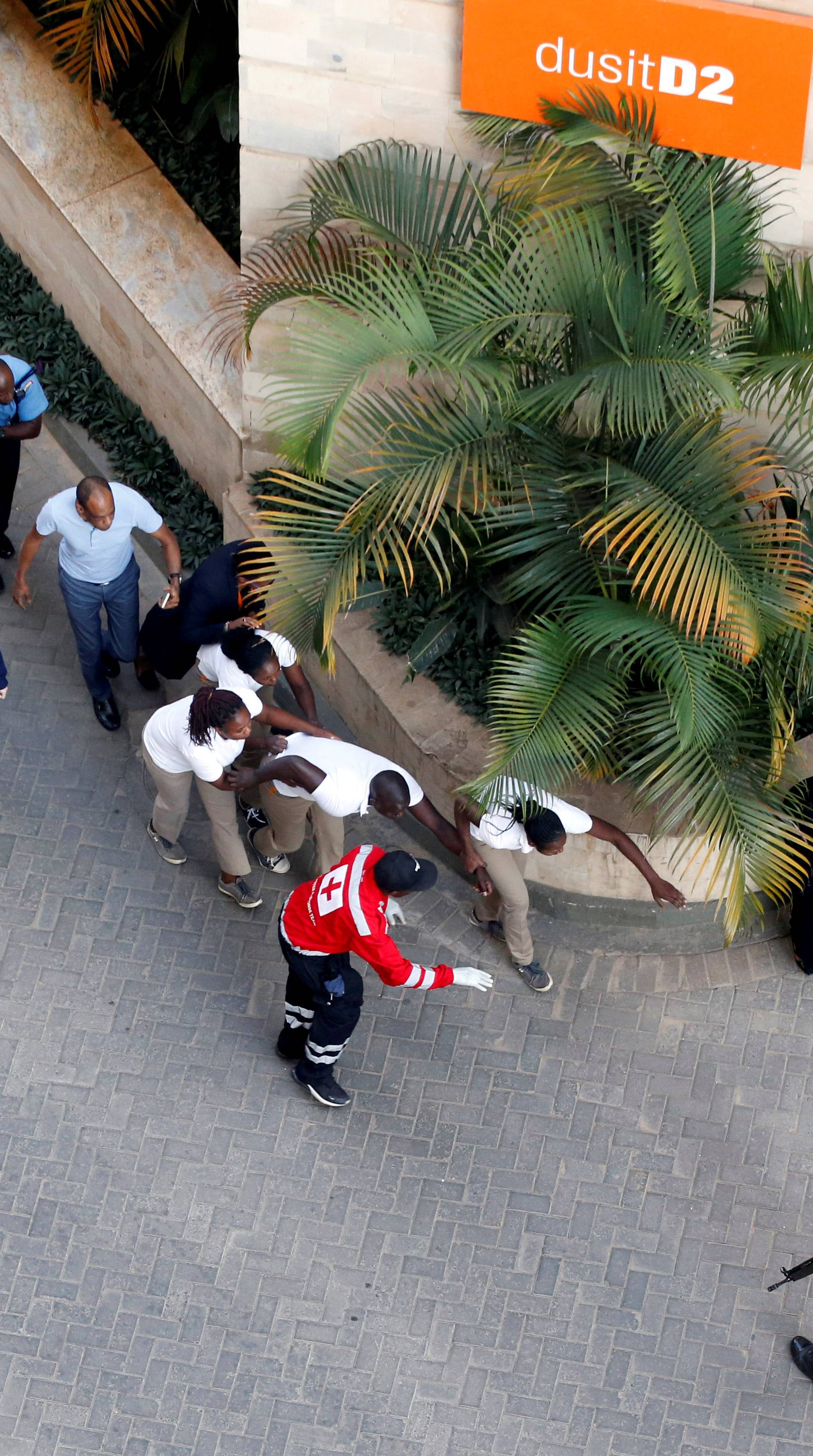 People are evacuated at the scene where explosions and gunshots were heard at the Dusit hotel compound, in Nairobi