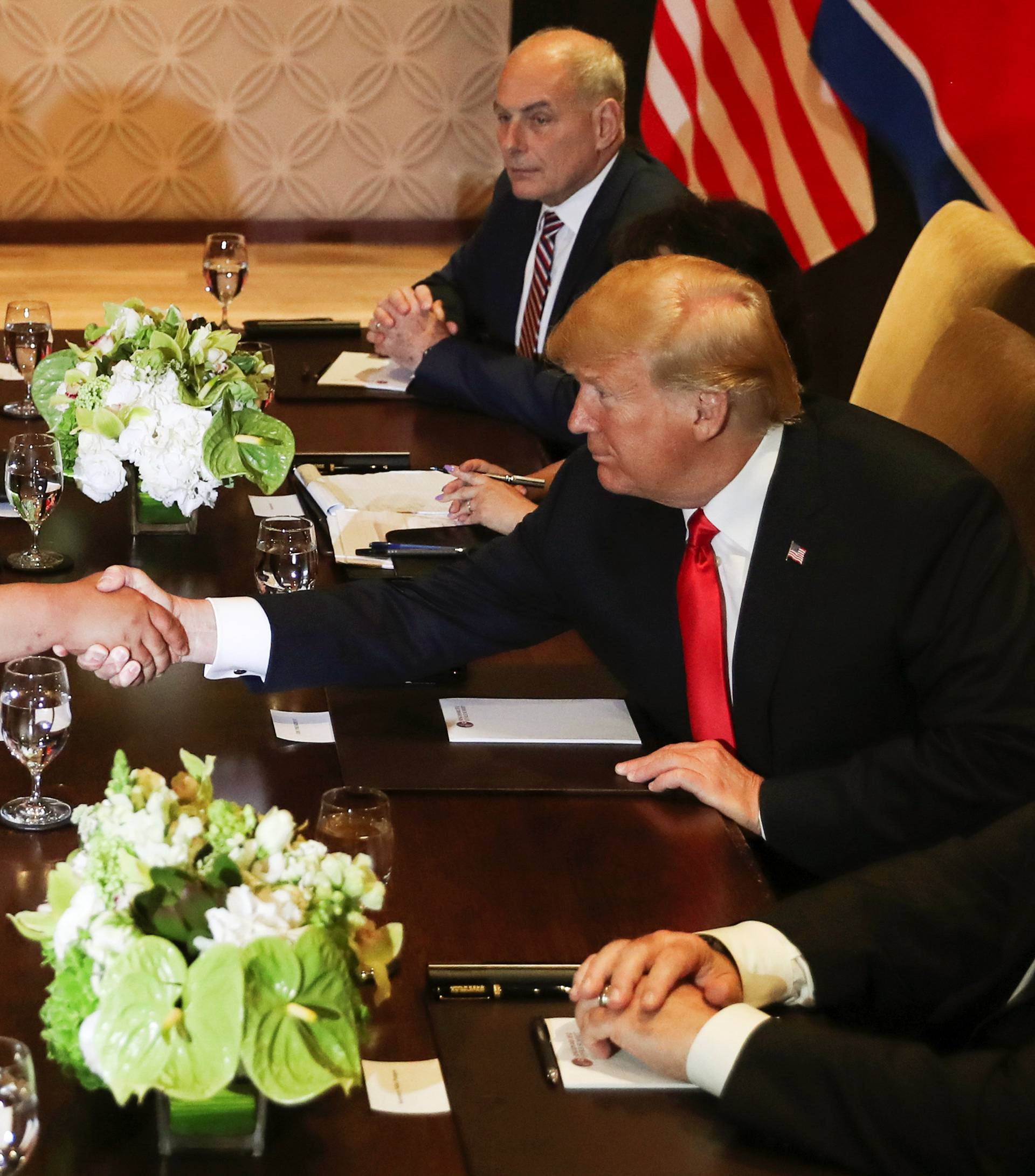 U.S. President Donald Trump shakes hands with North Korea's leader Kim Jong Un before their meeting in Singapore