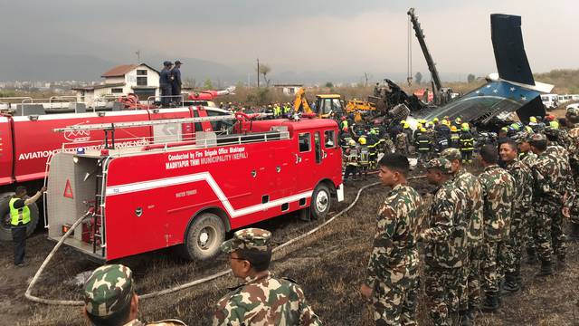 Wreckage of an airplane is pictured as rescue workers operate at Kathmandu airport