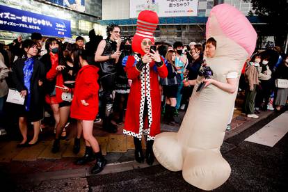 Revellers dressed in costumes stand by Shibuya crossing during Halloween, amid the coronavirus disease (COVID-19) pandemic, in Tokyo
