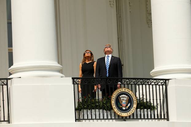 U.S. President Trump watches the solar eclipse with first Lady Melania Trump from the Truman Balcony at the White House in Washington