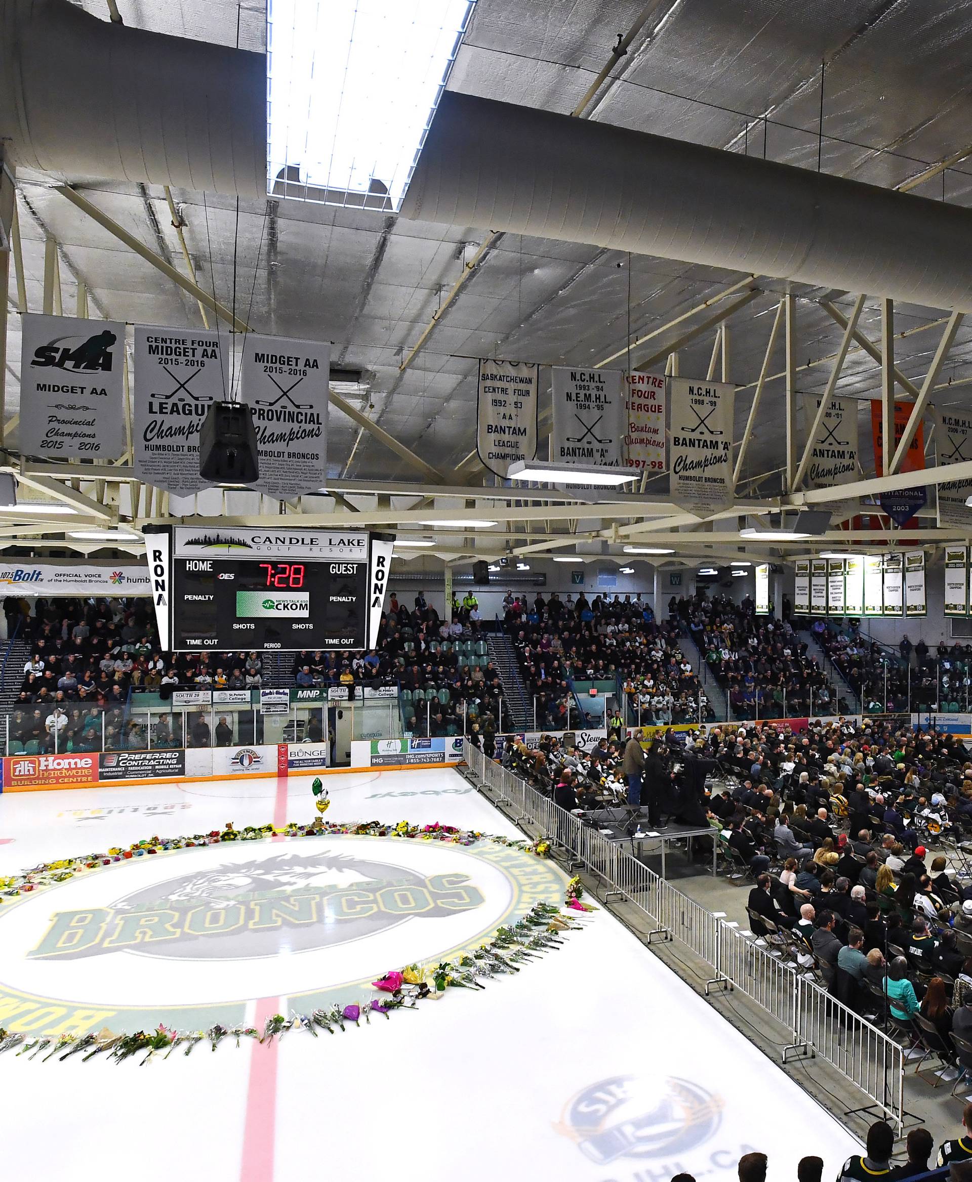 Flowers lie at centre ice as people gather for a vigil at the Elgar Petersen Arena, home of the Humboldt Broncos, to honour the victims of a fatal bus accident in Humboldt