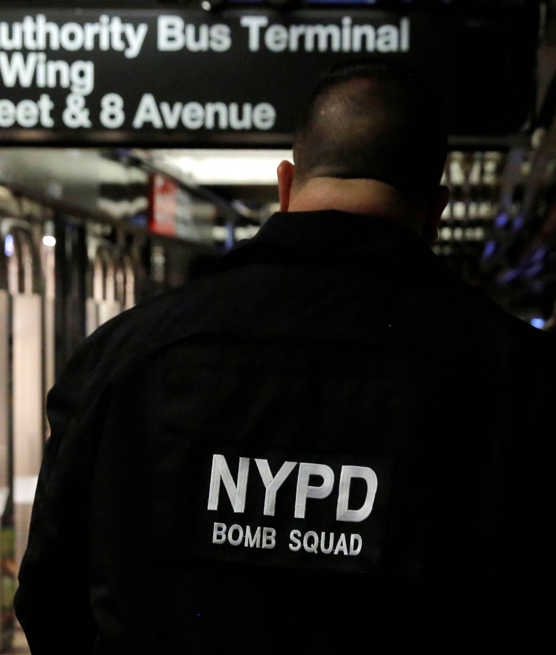 A member of the New York Police Department's Bomb Squad walks through the 42nd Street subway station beneath the New York Port Authority Bus Terminal following an attempted detonation during the morning rush hour, in New York City