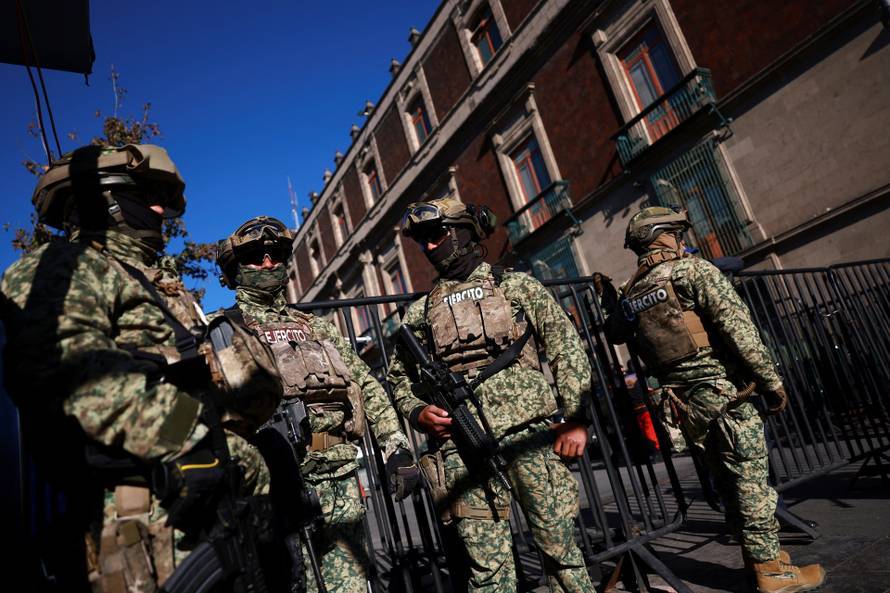 Members of the army patrol the perimeter of Palacio Nacional in Mexico