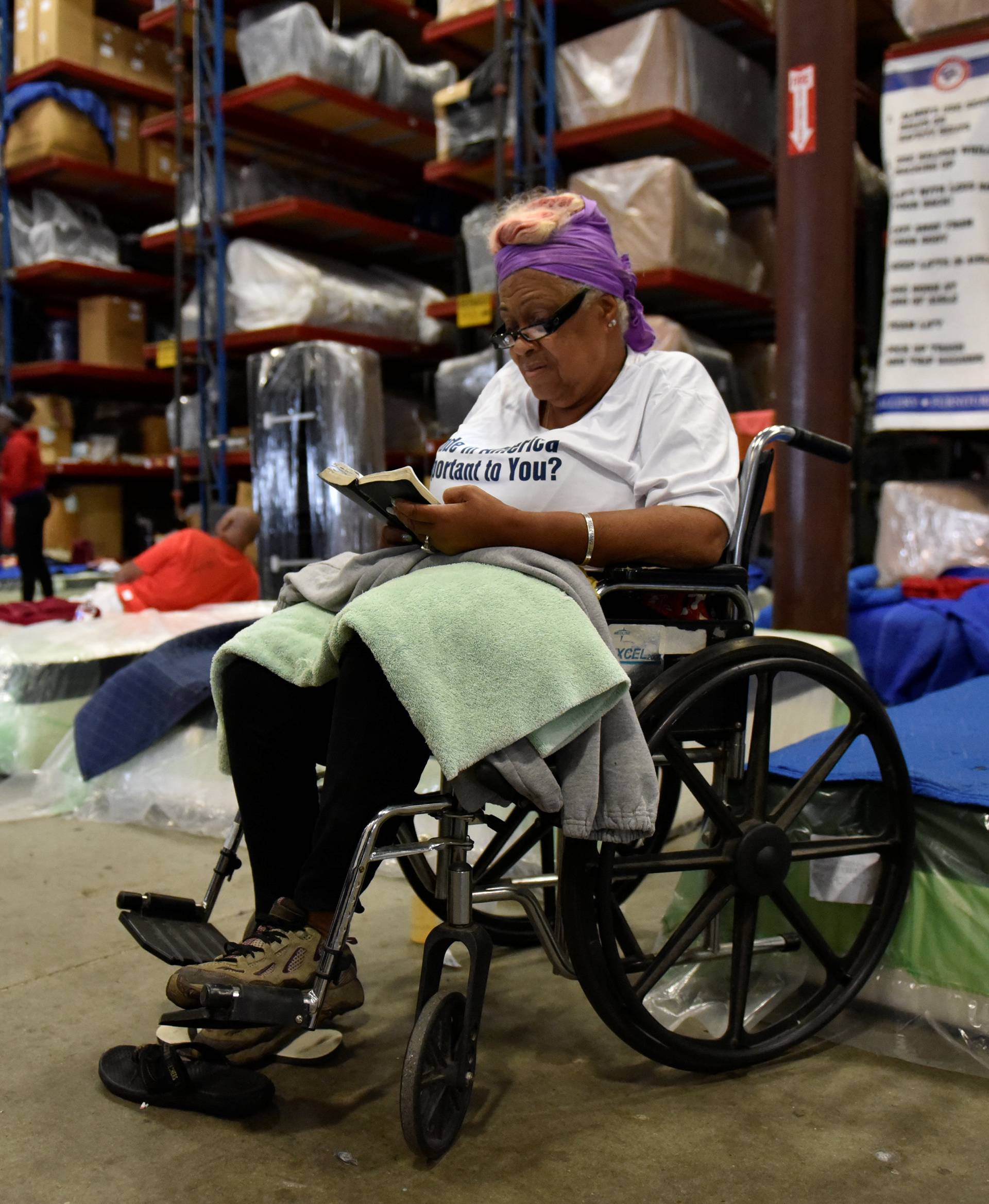 Mills reads her Bible in the warehouse at Gallery Furniture in Houston