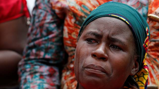 A parent of one of the abducted Chibok school girls cries after the police prevented the parents access to see President Muhammadu Buhari during a rally in Abuja, Nigeria