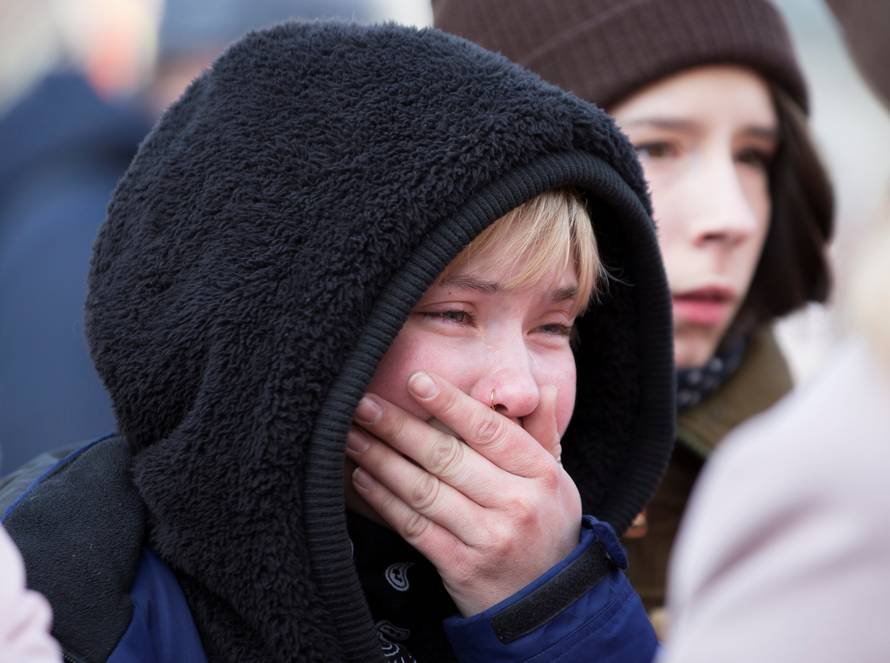 A youth mourns the victims of a shopping mall fire at a makeshift memorial in the Siberian city of Kemerovo