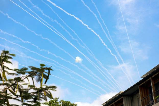 The contrails of rockets launched from the Gaza Strip towards Israel are seen from Sderot, southern Israel