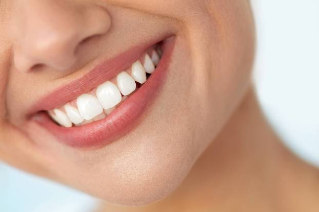 Closeup Of Beautiful Smile With White Teeth. Woman Mouth Smiling