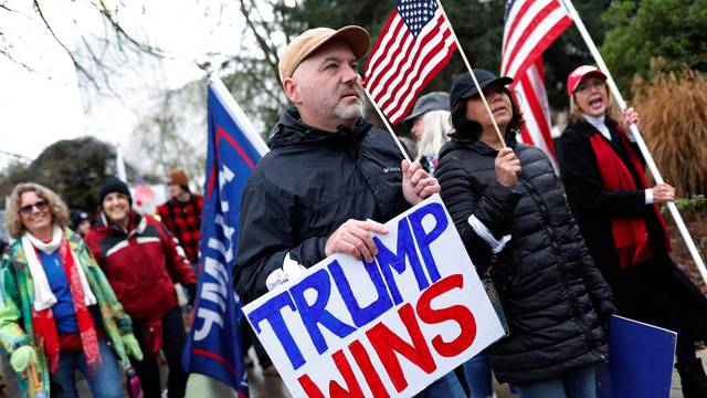A protester holds a sign saying "Tump wins" at a rally in support of U.S. President Donald Trump at the Oregon State Capitol in Salem