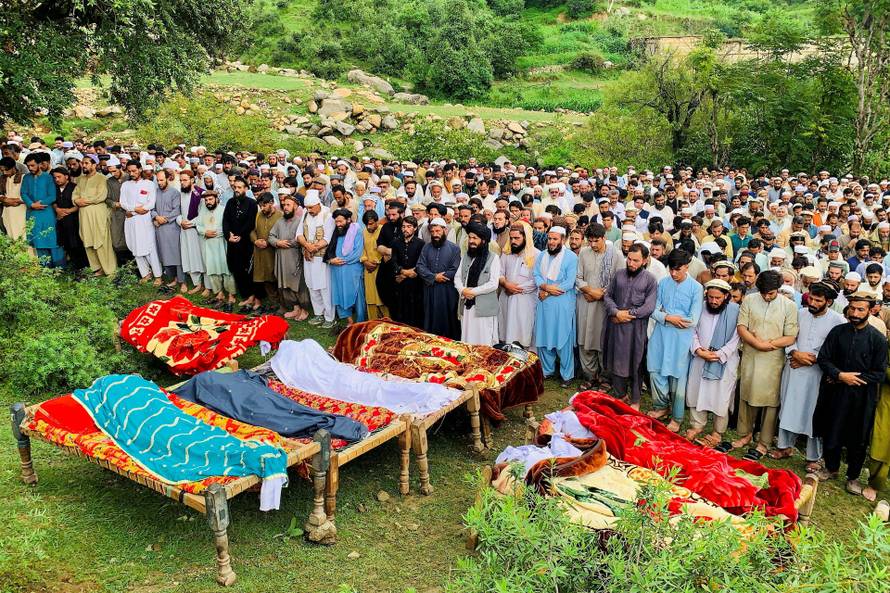 Residents attend the funeral of te victims of cloudburst following heavy rains and flooding, in Salarzai