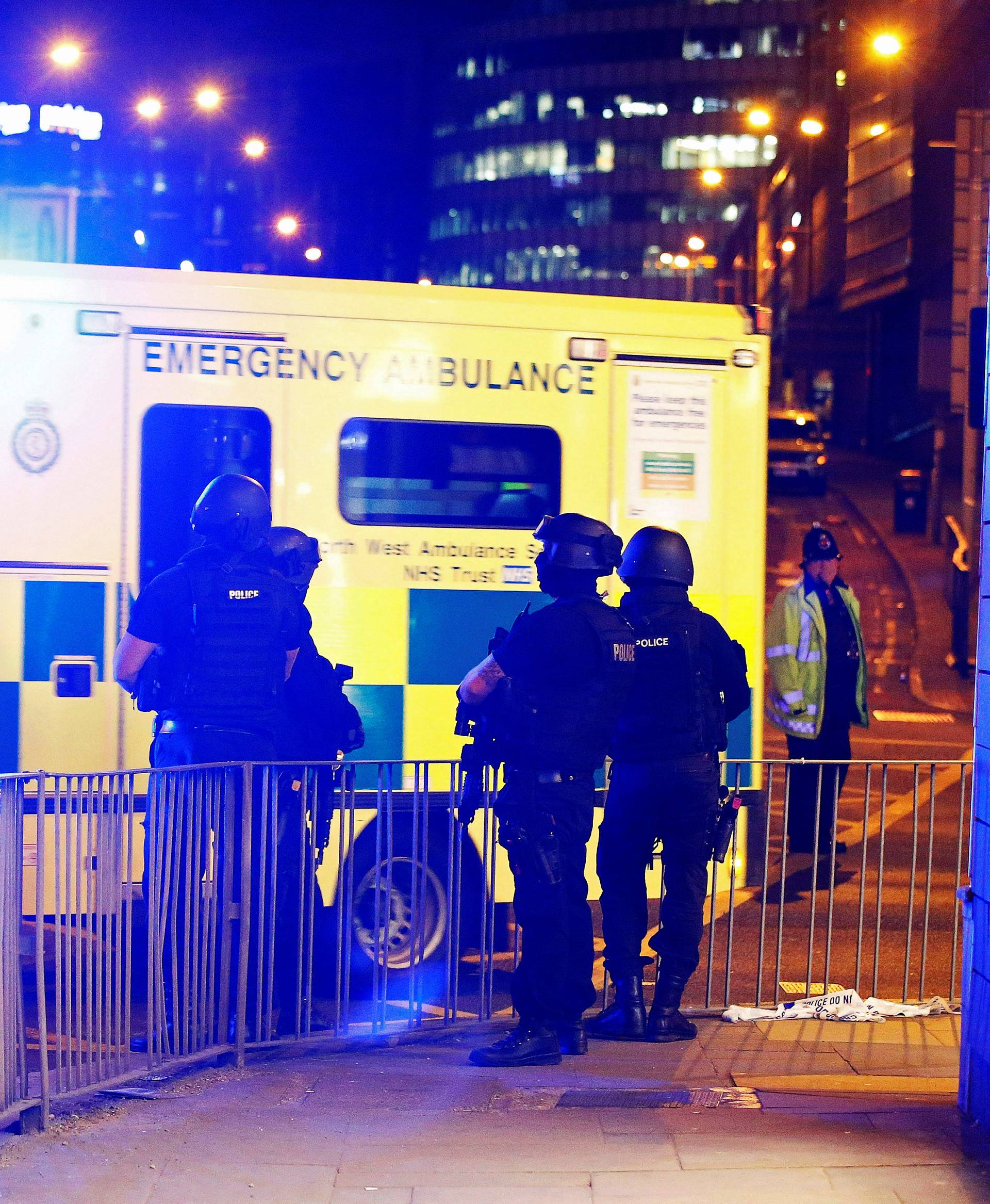 Armed police officers stand near the Manchester Arena, where U.S. singer Ariana Grande had been performing, in Manchester, in northern England, Britain