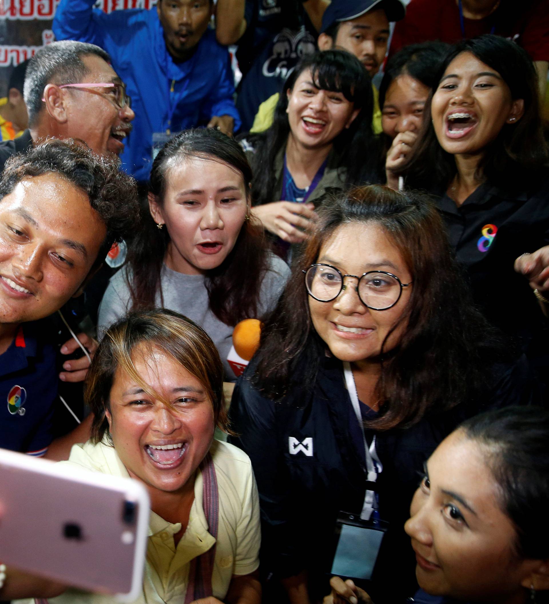 Journalists celebrate after a news conference near Tham Luang cave complex in the northern province of Chiang Rai