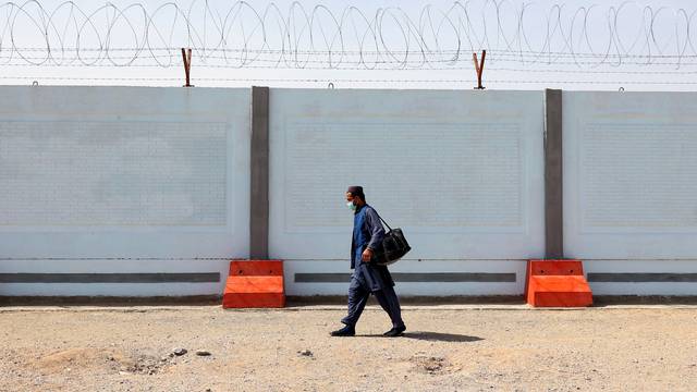 FILE PHOTO: An Afghan man walks at an Afghan refugee camp in Zahedan