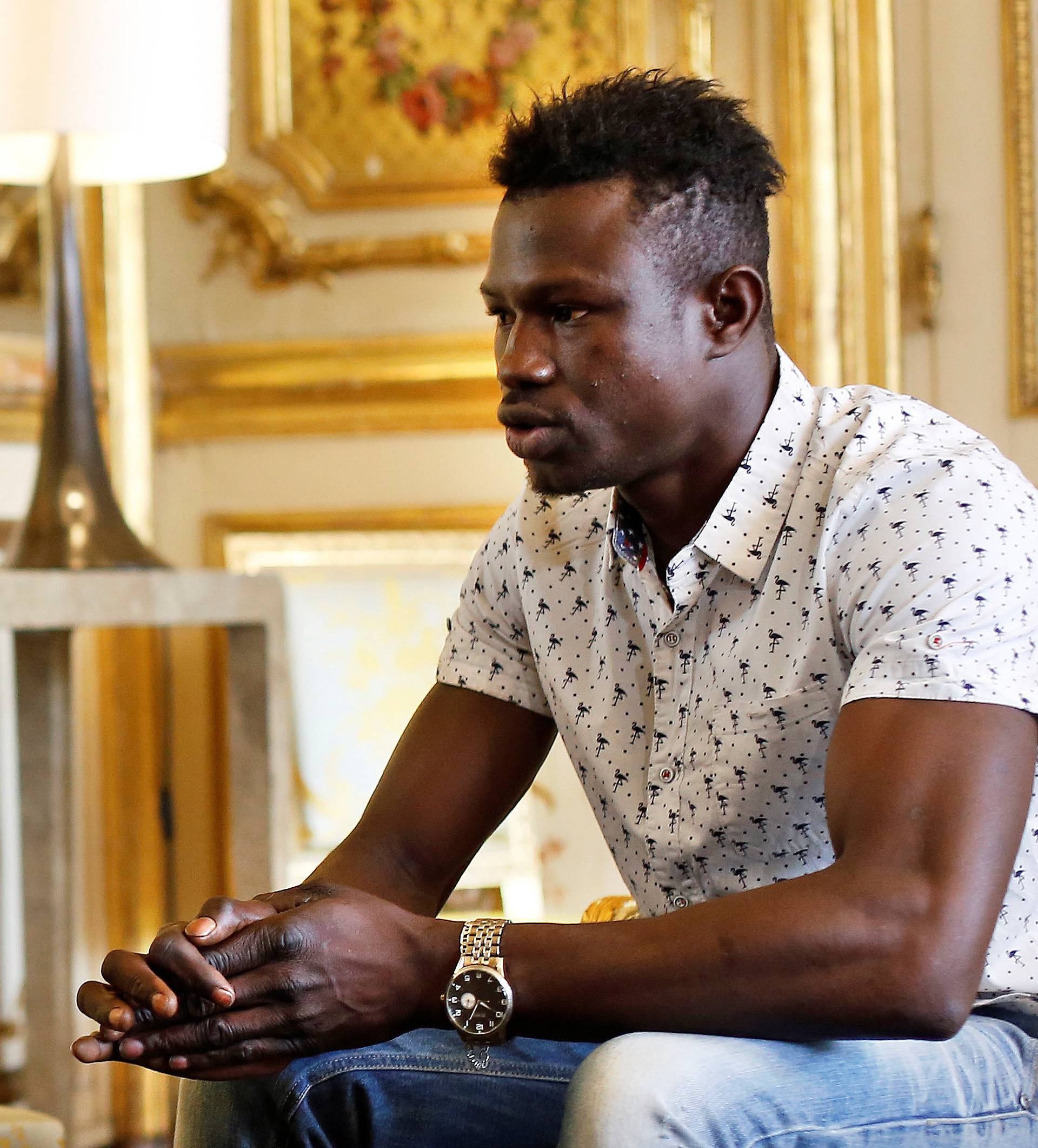 Mamoudou Gassama, 22, from Mali, is pictured during a meeting with French President Emmanuel Macron at the Elysee Palace in Paris
