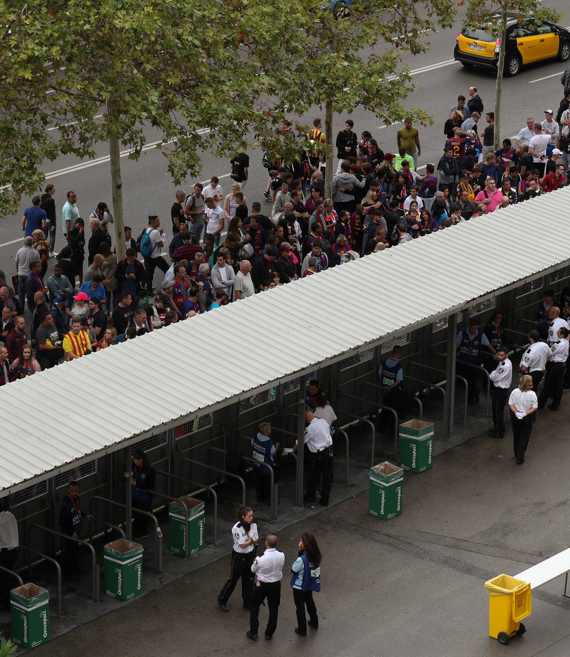 People wait outside Camp Nou stadium for news on whether the Spanish La Liga soccer match between Barcelona and Las Palmas will go ahead as planned in Barcelona