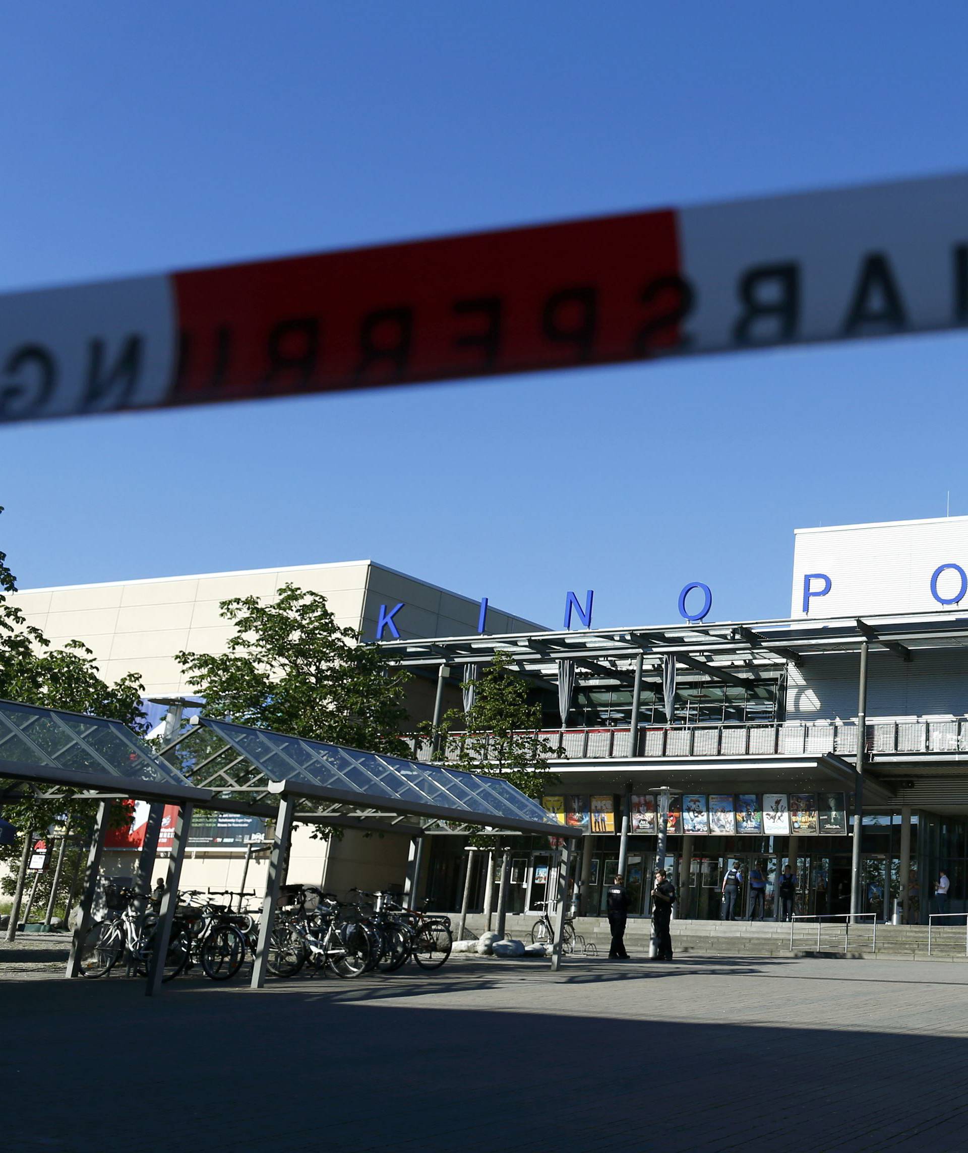 Warning tape is pictured in front of a cinema complex after a masked man with a gun and ammunition belt opened fire in Viernheim