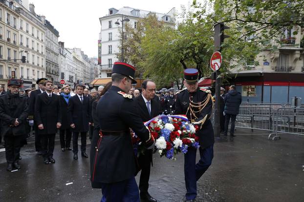 French President Francois Hollande and Paris Mayor Anne Hidalgo unveil a commemorative plaque next to the "A La Bonne Biere" cafe