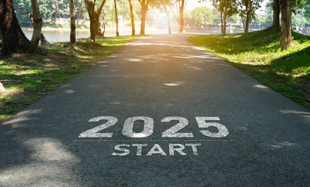 Happy new year, 2025 symbolizes the start of the new year. The letter start new year 2025 on the road in the nature route roadway have tree environment ecology or greenery wallpaper concept.