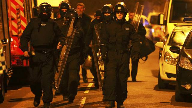 Prison officers in riot gear arrive at Winson Green prison, run by security firm G4S, after a serious disturbance broke out, in Birmingham