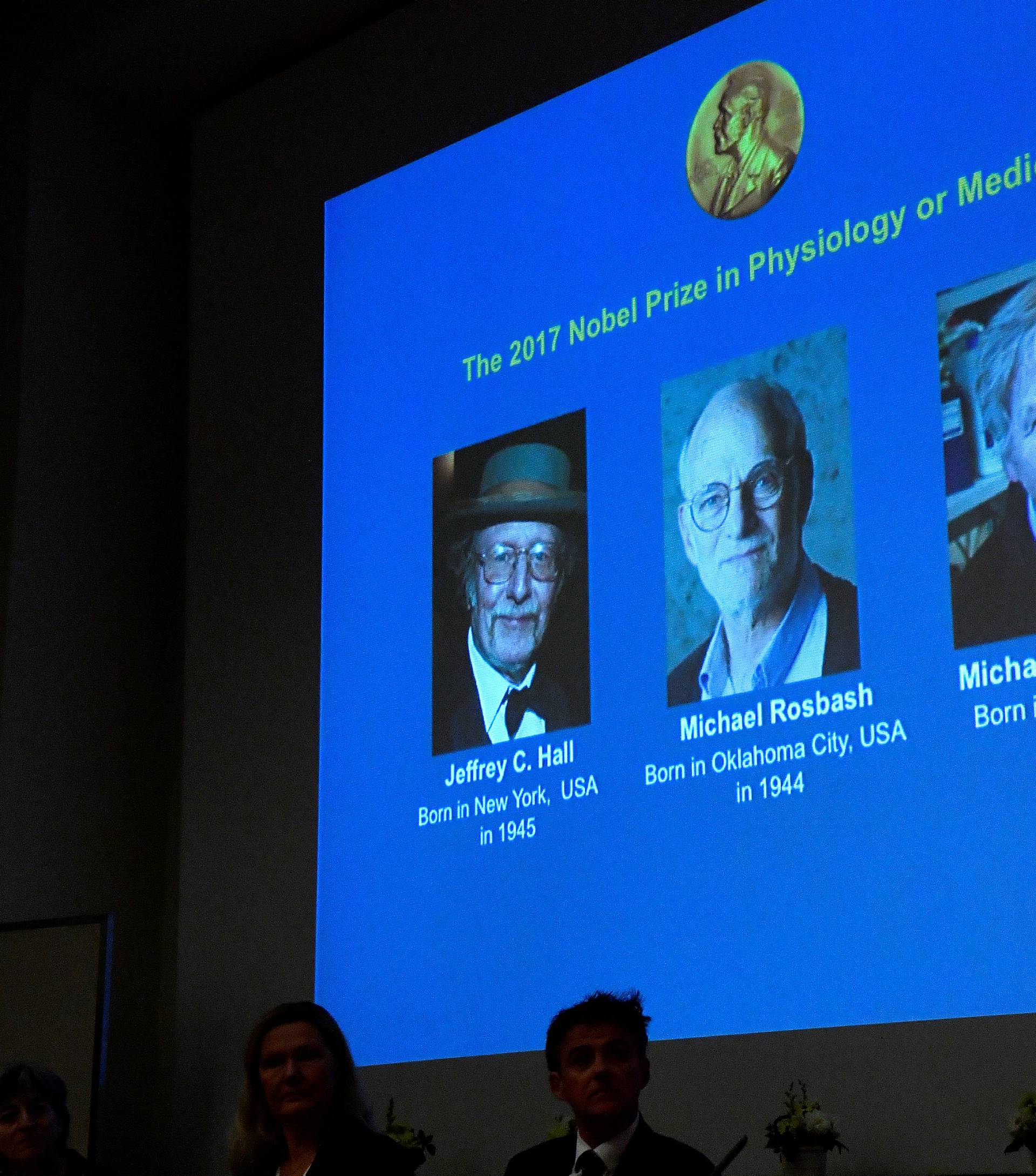 The names of Jeffrey C. Hall, Michael Rosbash and Michael W. Young are displayed during a news conference to announce the winner of the Nobel Prize in Physiology or Medicine 2017, in Stockholm