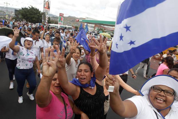 Supporters of President Hernandez gesture during a march in support of Hernandez in Tegucigalpa