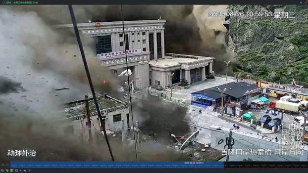 A CCTV footage shows people running away as wall of mud and water destroys buildings in a valley at Nepal-China border, in Gyirong