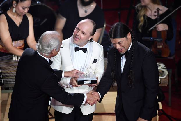King Carl Gustaf of Sweden gives out the Polar Music Prize to Lars Ulric and Robert Trujillo in Metallica during an award cermony at Grand Hotel in Stockholm