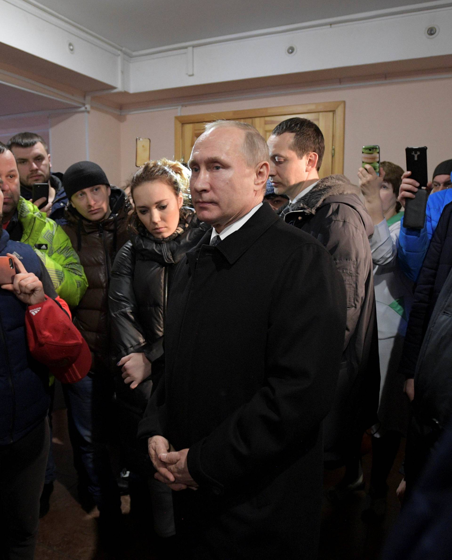 Russian President Vladimir Putin meets with locals and relatives of persons missing in a fire in a shopping mall in Kemerovo
