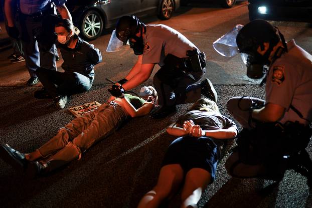 Police detain protesters for blocking traffic during a rally against racial inequality and the police shooting death of Rayshard Brooks, in Atlanta