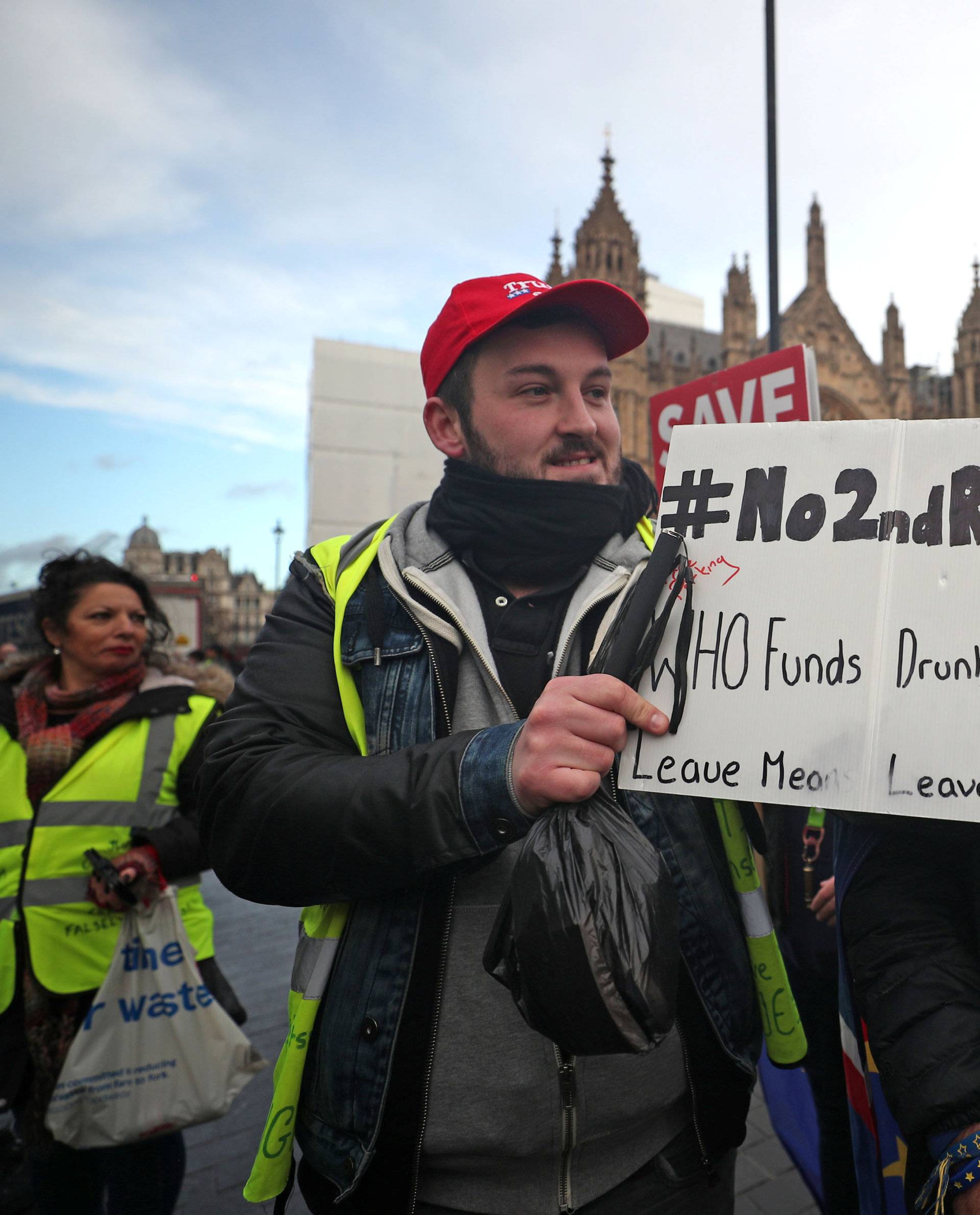 Pro-Brexit and pro-EU supporters hold flags and placards outside the Houses of Parliament in Westminster London