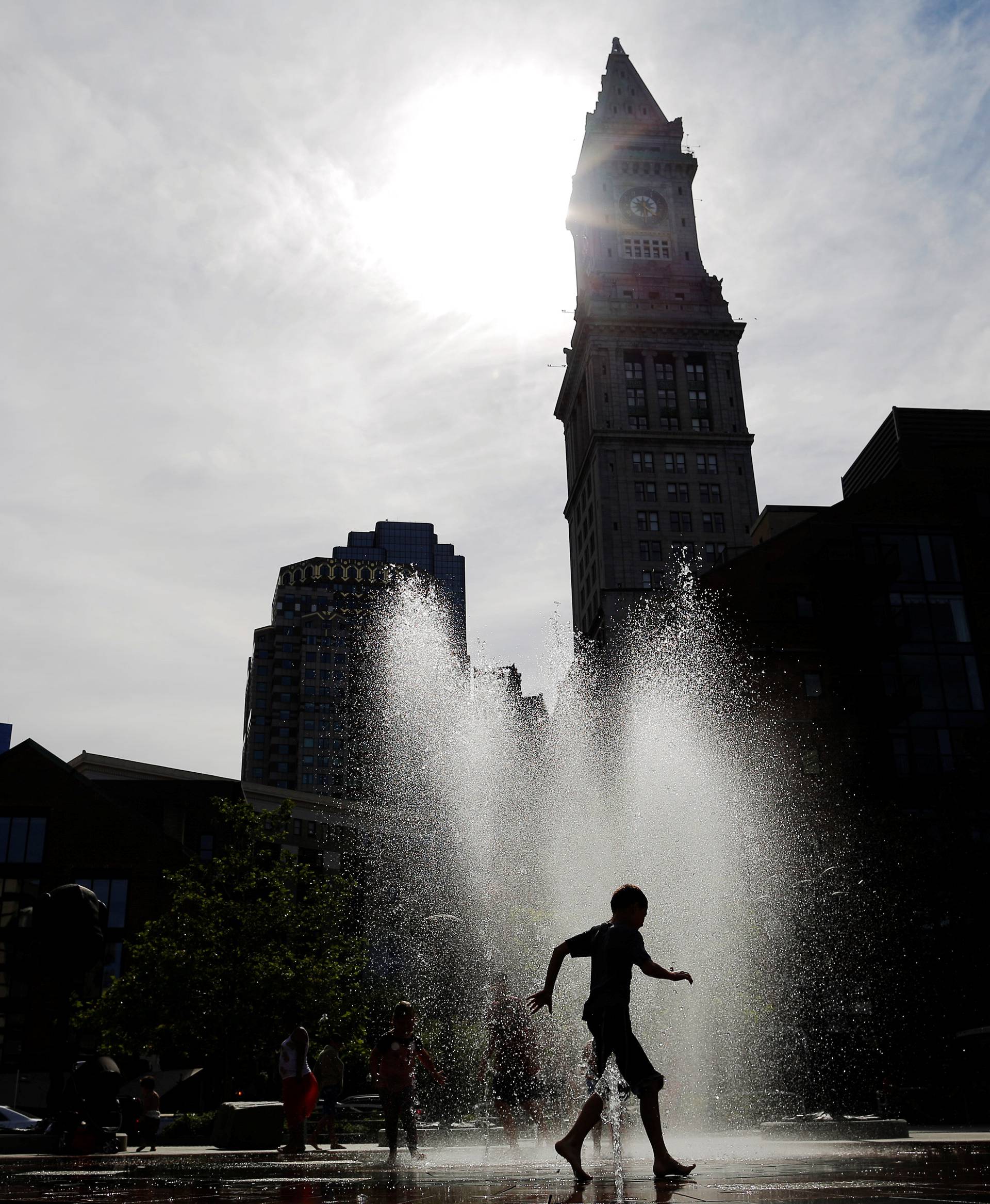 People cool off in fountain on the Rose Kennedy Greenway on summer afternoon in Boston
