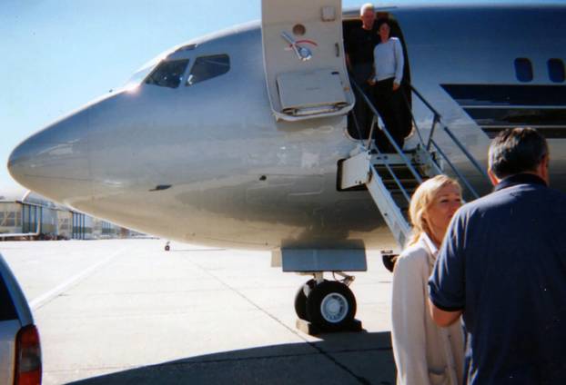 *PREMIUM EXCLUSIVE*  Bill Clinton and Ghislaine Maxwell pose together for the camera as the pair prepare to board Jeffrey Epsteins notorious private jet.