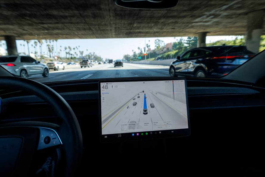 A 2025 Tesla Model 3 self-drives with FSD 14.1.4 software on a Los Angeles freeway