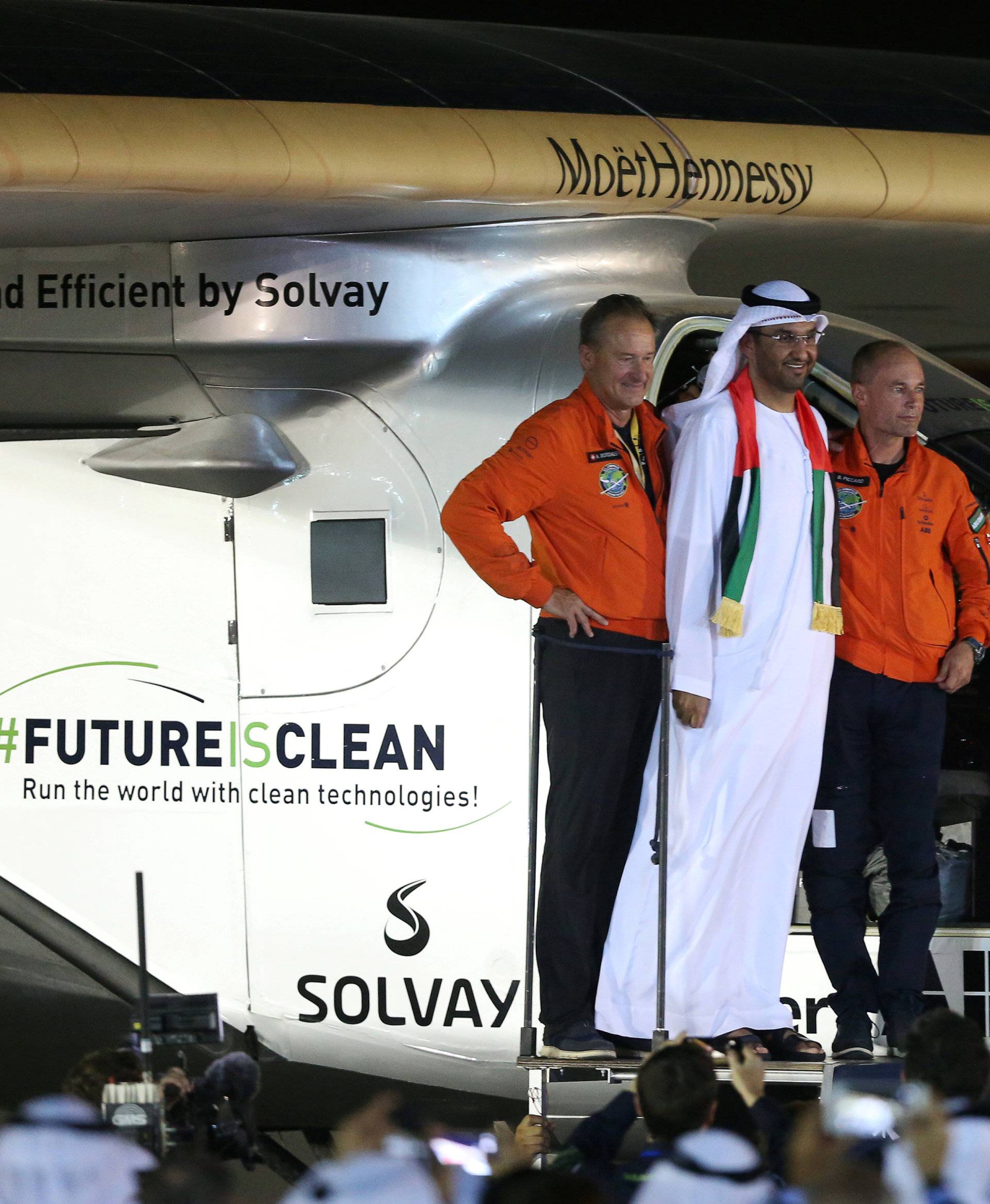 Pilot Andre Borschberg and Bertrand Piccard pose with Sultan Ahmed al-Jaber following the arrival of Solar Impulse 2, a solar powered plane, at an airport in Abu Dhabi