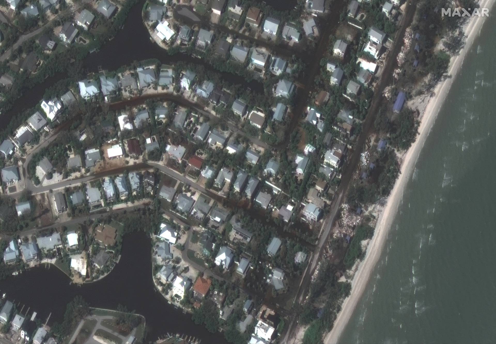 A satellite view shows flooded streets and storm debris after the passing of Hurricane Milton, in Anna Maria Island, Florida