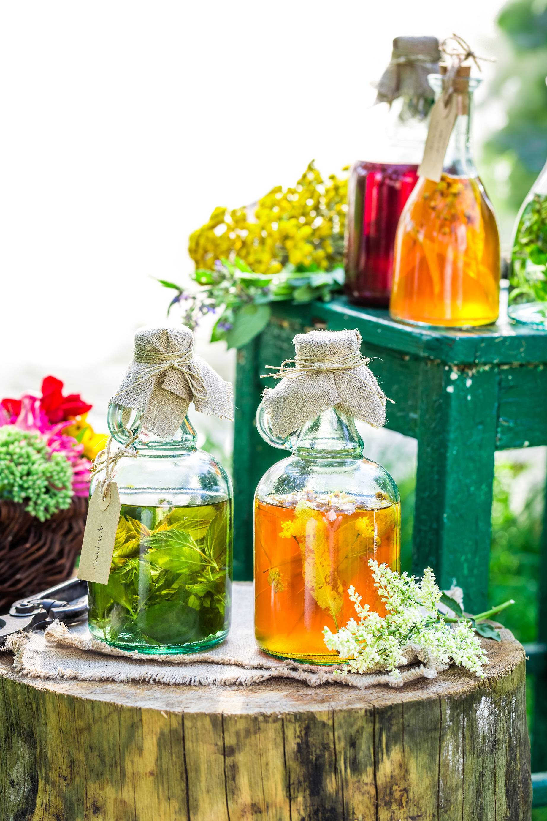 Healing herbs in bottles with alcohol and herbs