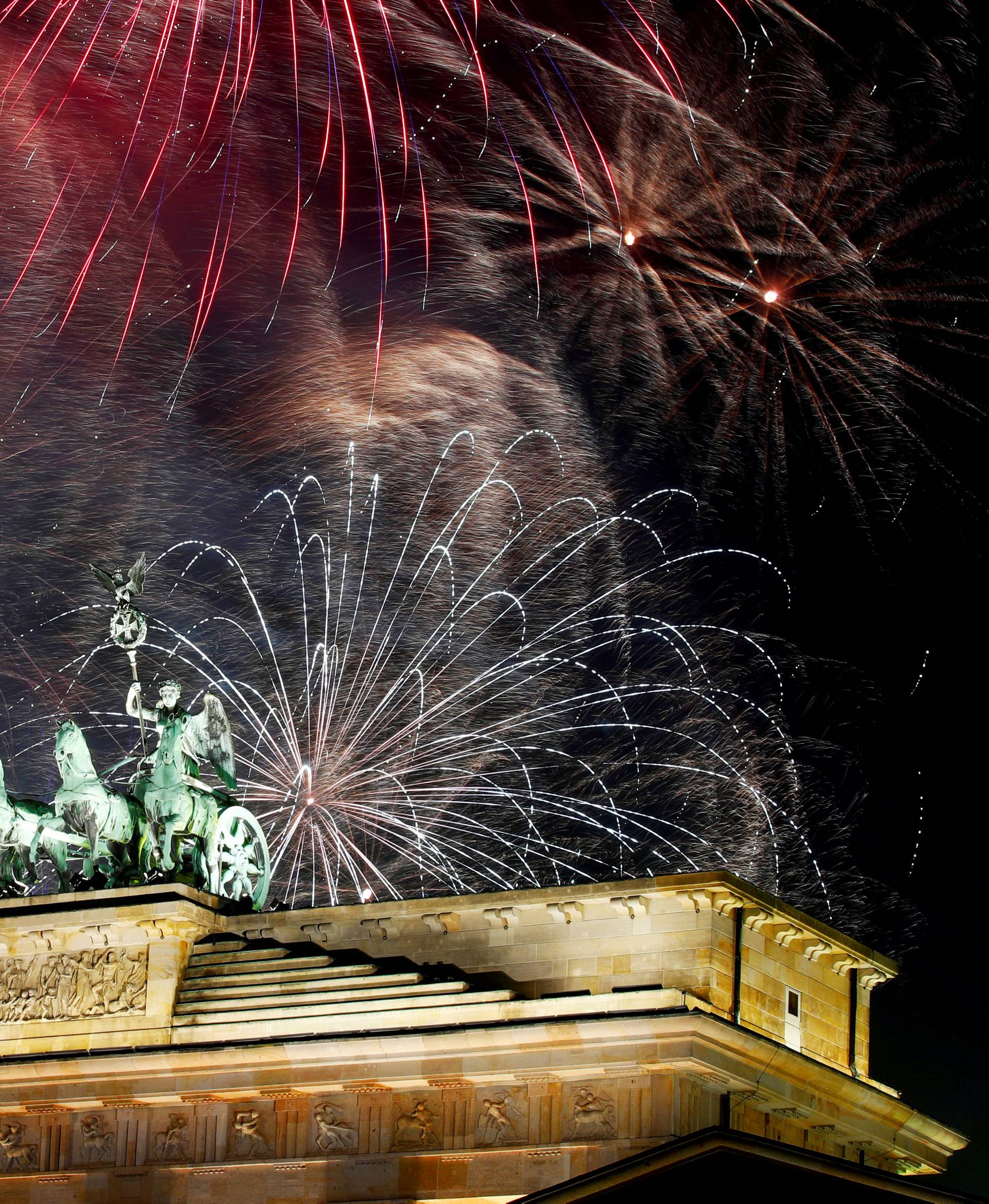 Fireworks explode over the Quadriga sculpture atop the Brandenburg gate during New Year celebrations in Berlin, Germany