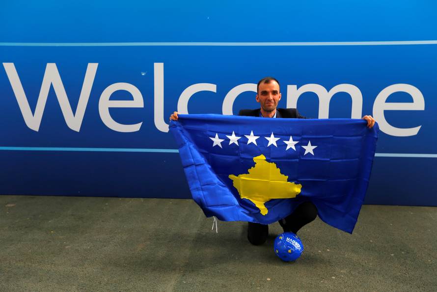 A member of the Kosovo media team celebrates outside the convention centre where the European football group UEFA admitted Kosovo as its newest member in Budapest