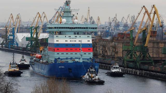 The nuclear-powered icebreaker Arktika is seen drawn by tug boats as it starts the sea trials, in Saint Petersburg