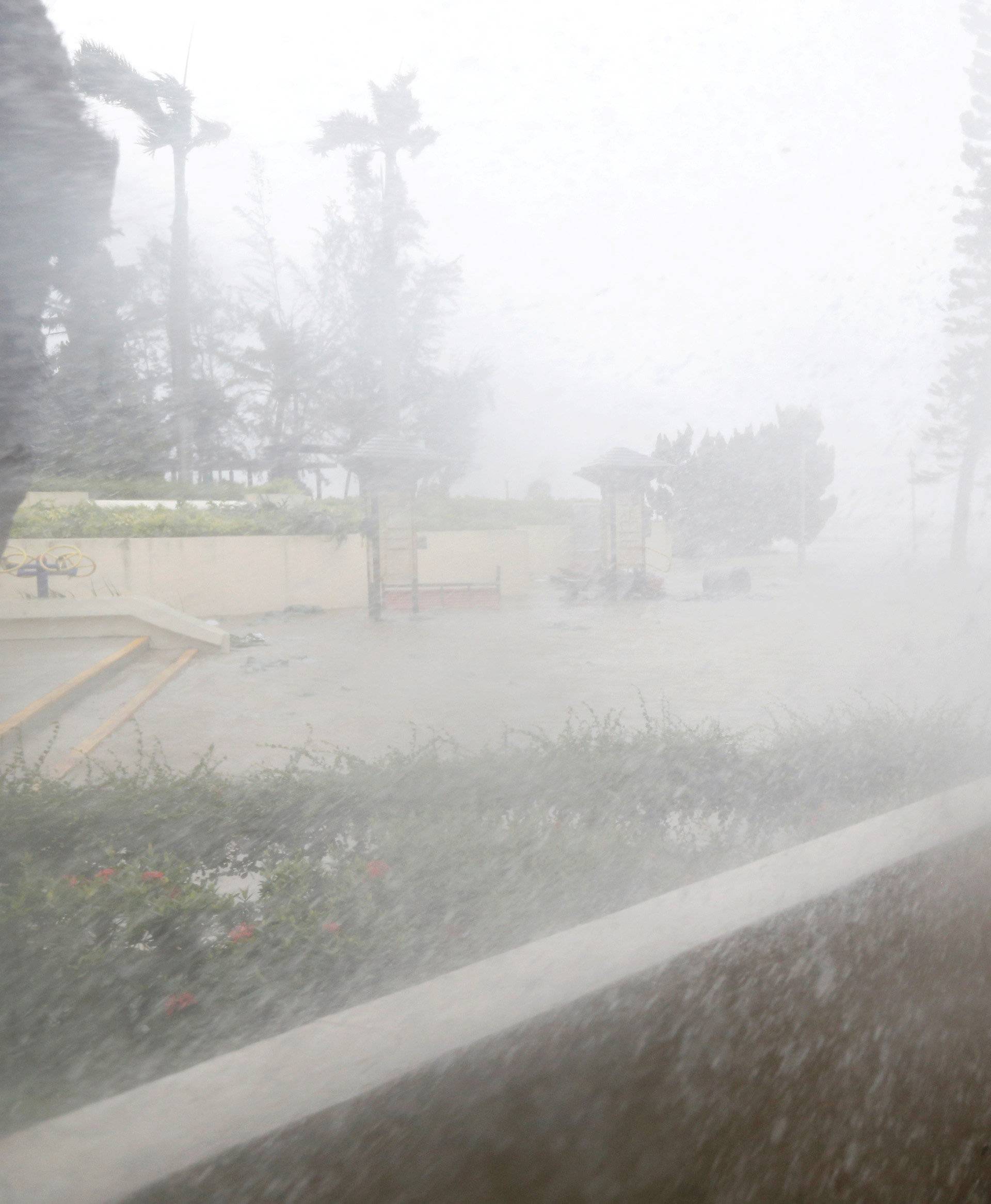 A journalist braves high waves under Typhoon Mangkhut attack in Hong Kong