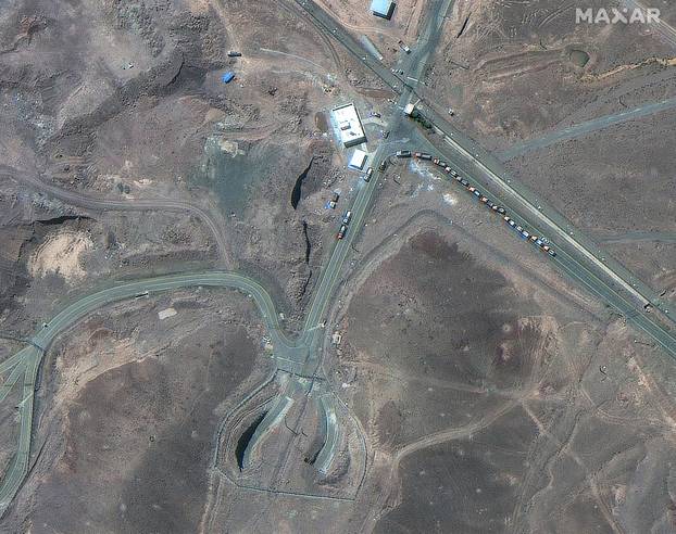 A satellite image shows trucks positioned near the entrance of the Fordow fuel enrichment facility, near Qom