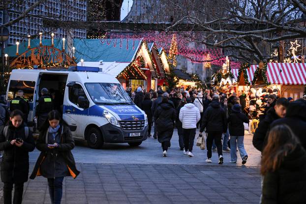 A police car secures an entrance of the Christmas market on the Breitscheidplatz, in Berlin