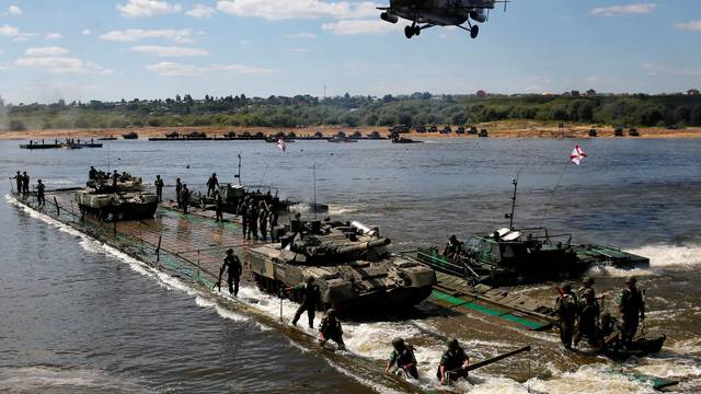 Russian crew members transport T-80 tanks on pontoon bridge during Open Water competition at International Army Games 2016 in Murom