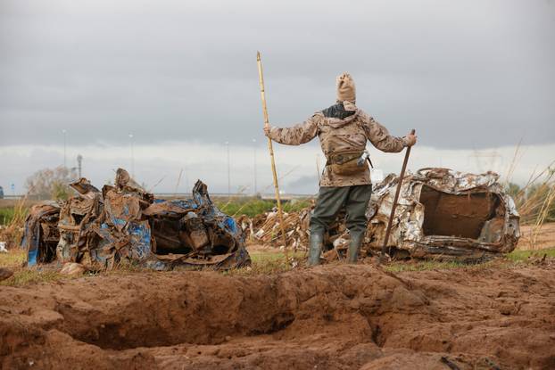 Members of the military search for bodies of people missing after heavy rains, in Quart de Poblet