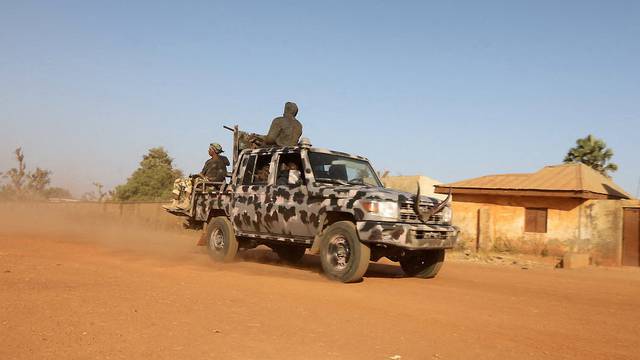 FILE PHOTO: Members of security forces ride a truck as they patrol in Kankara
